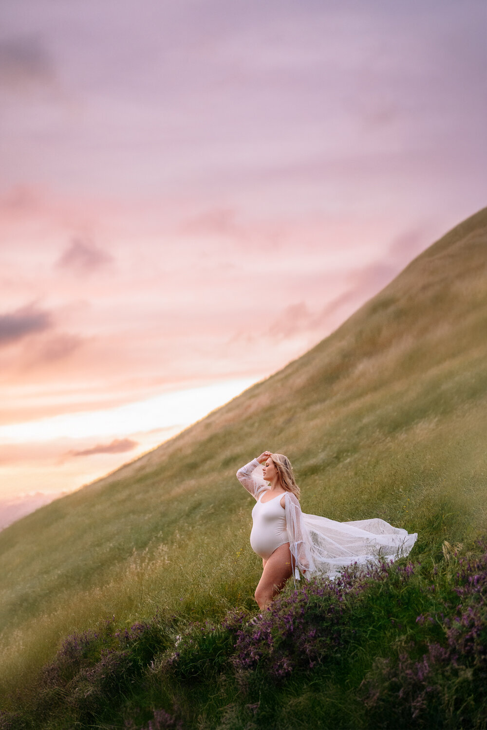 pregnant mom in white maternity body suit on a large walnut creek hill