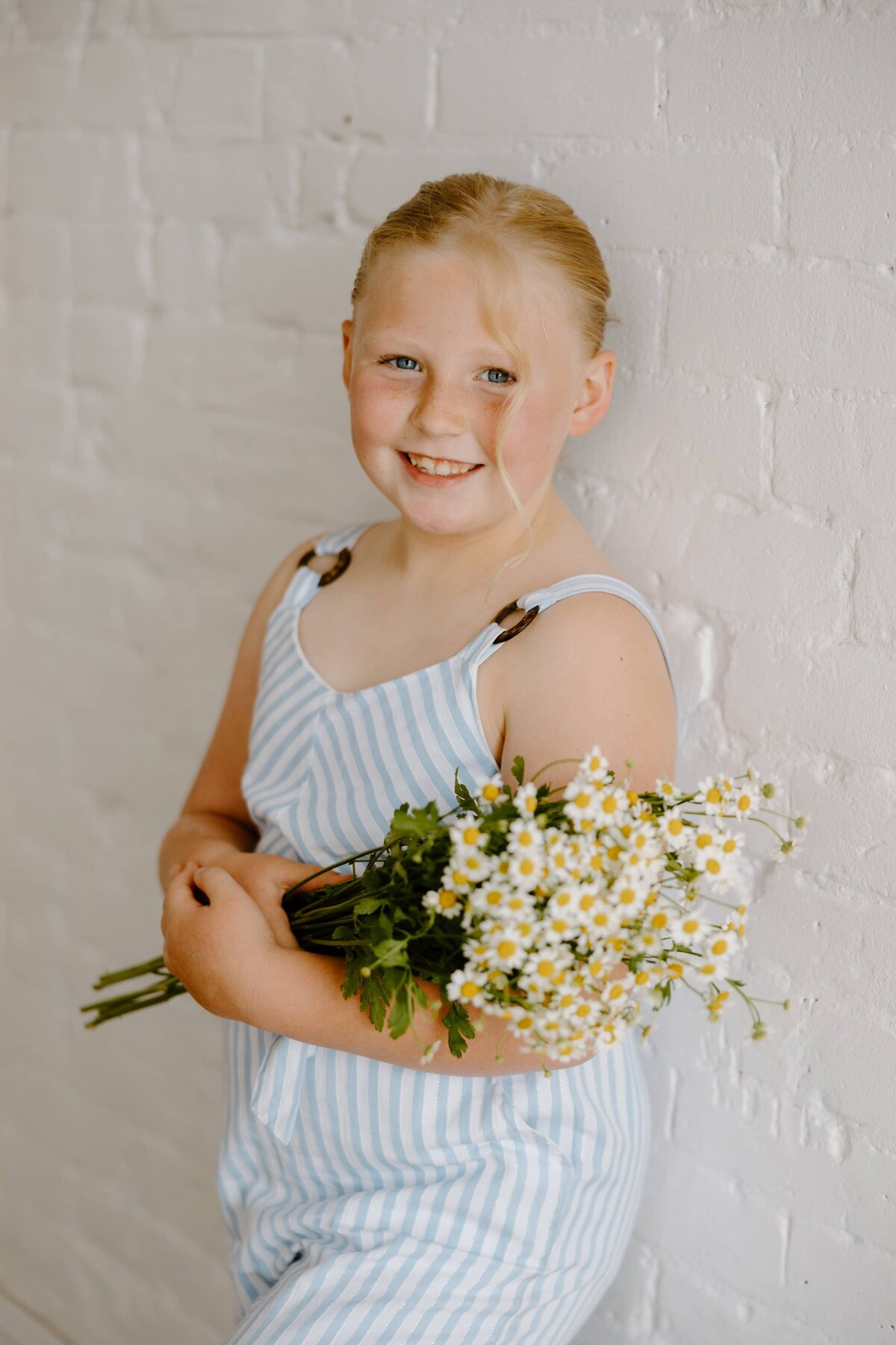 A girl poses for a photo in a studio in Fort Collins, Colorado.