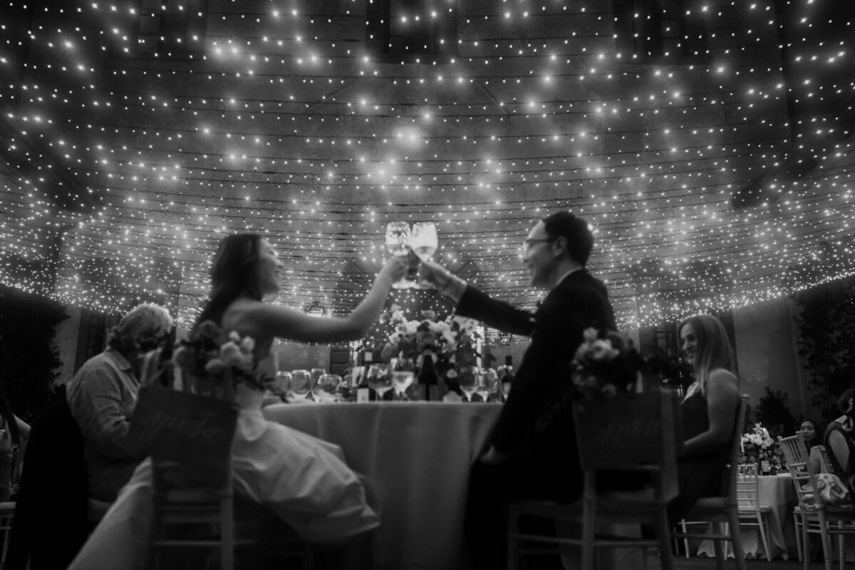 bride-and-groom-at-villa-mangiacane-dinner-cheers-scaled-2048x1366