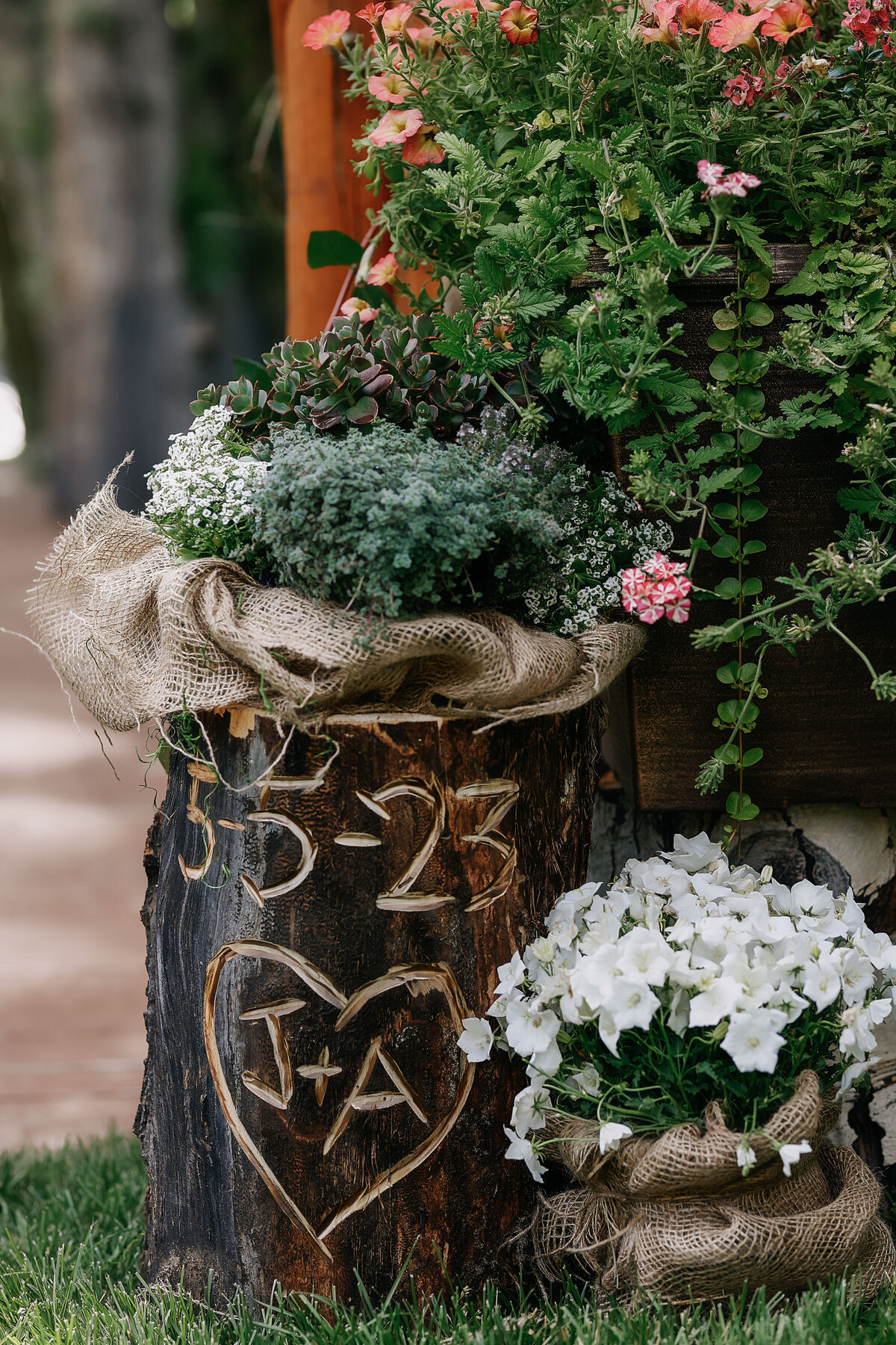 A rustic log, carved with the initials J + A for beautiful wedding decor.