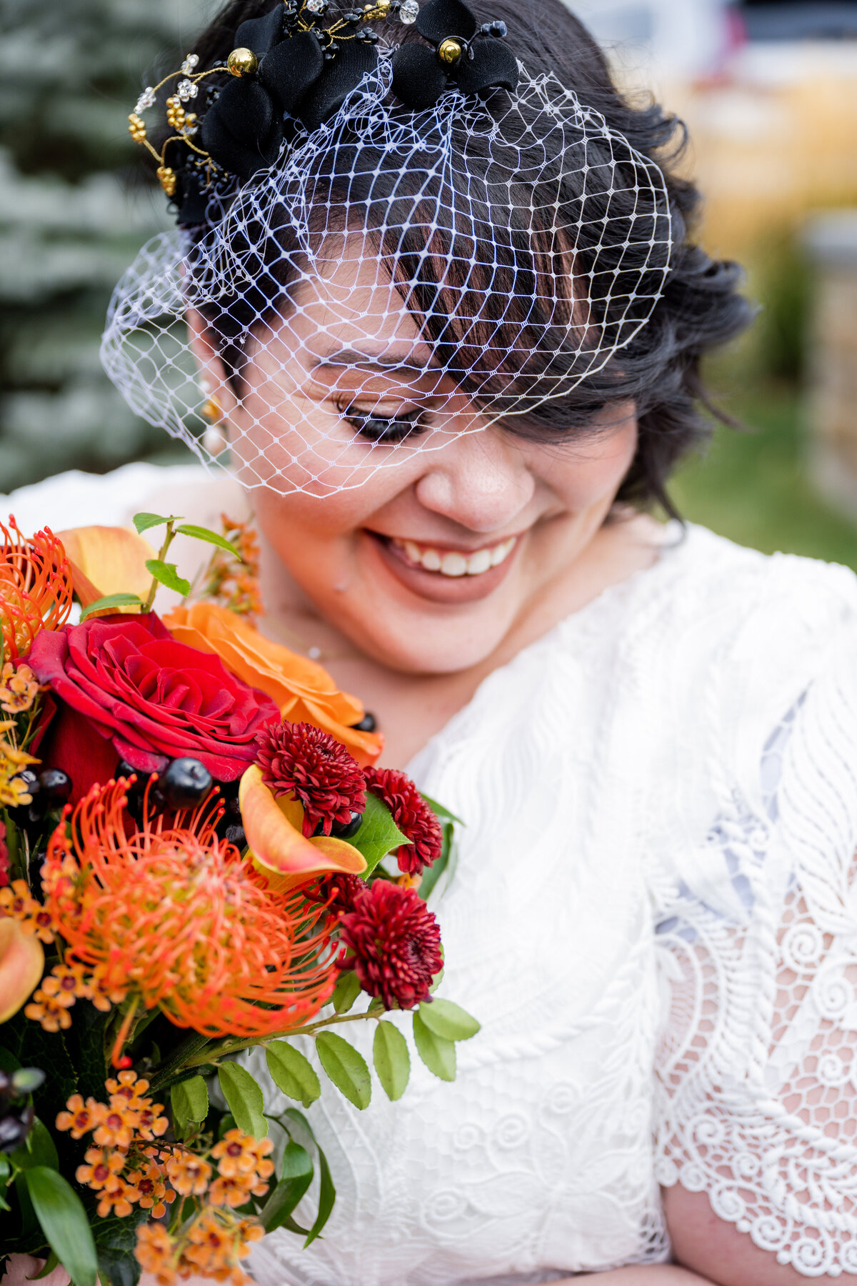 bride-holding-bright-orange-and-burgandy-bridal-bouquet