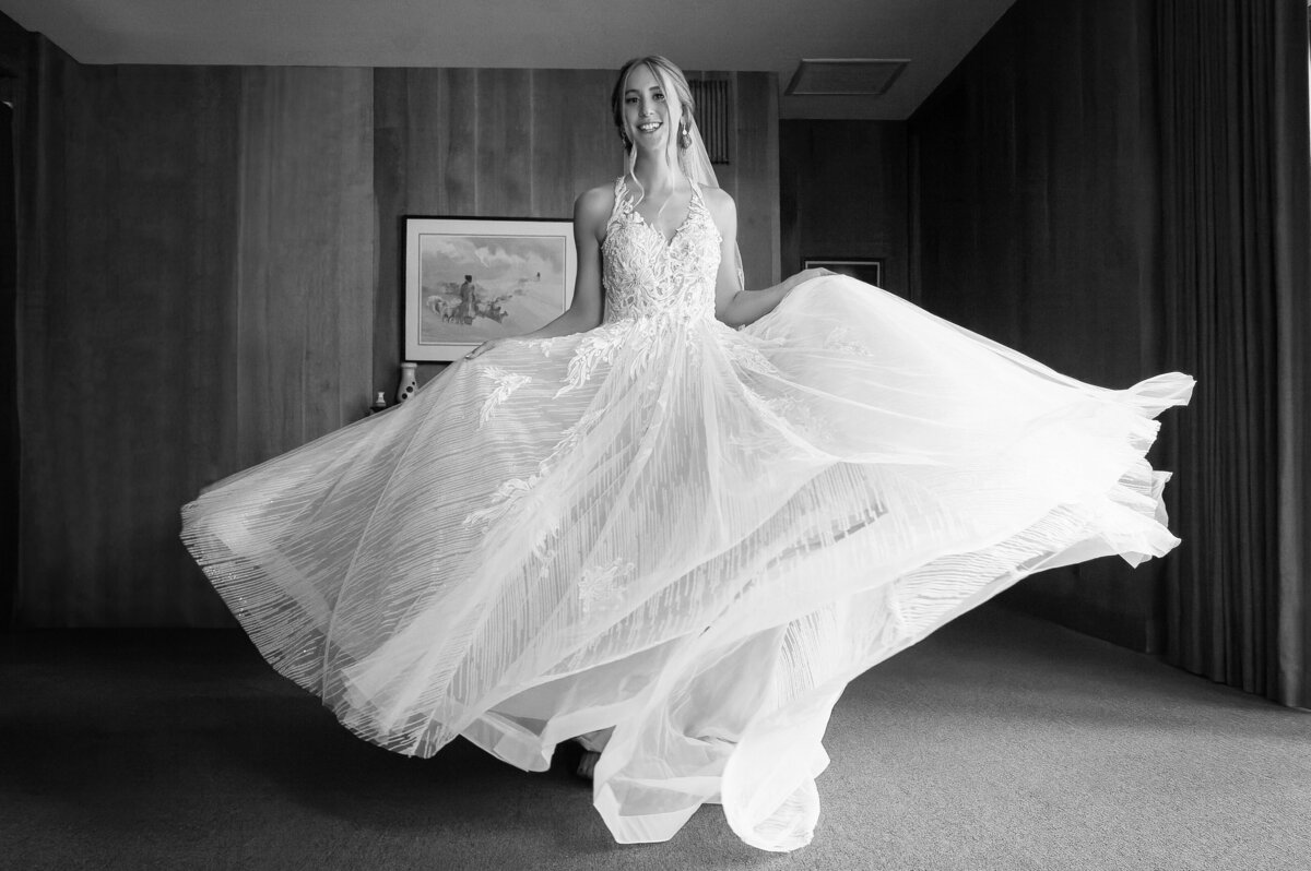 Bride twirls in her wedding dress on her wedding day