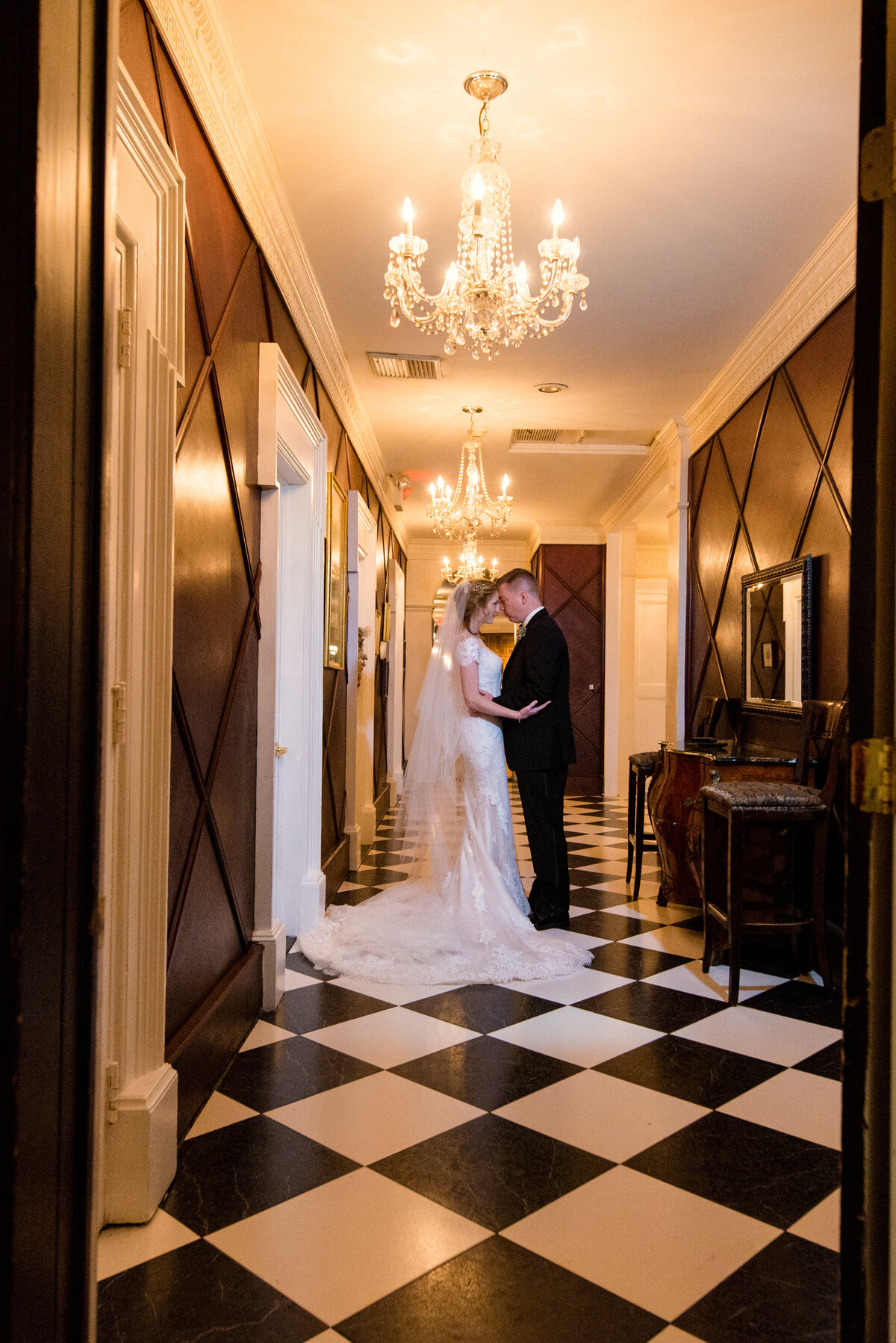 bride and groom kissing in hallway from wedding at The Carltun