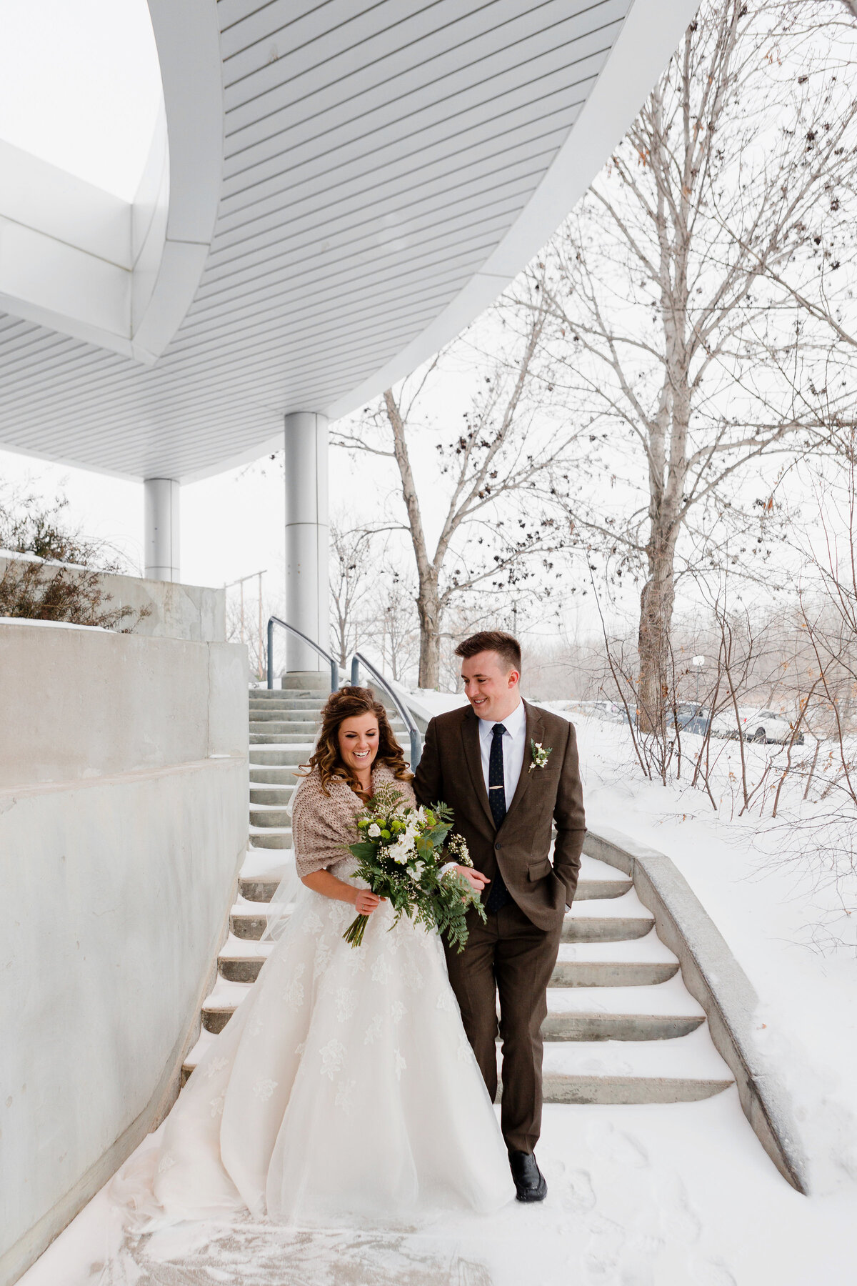 Winter wedding in Regina outside the IMAX for photos