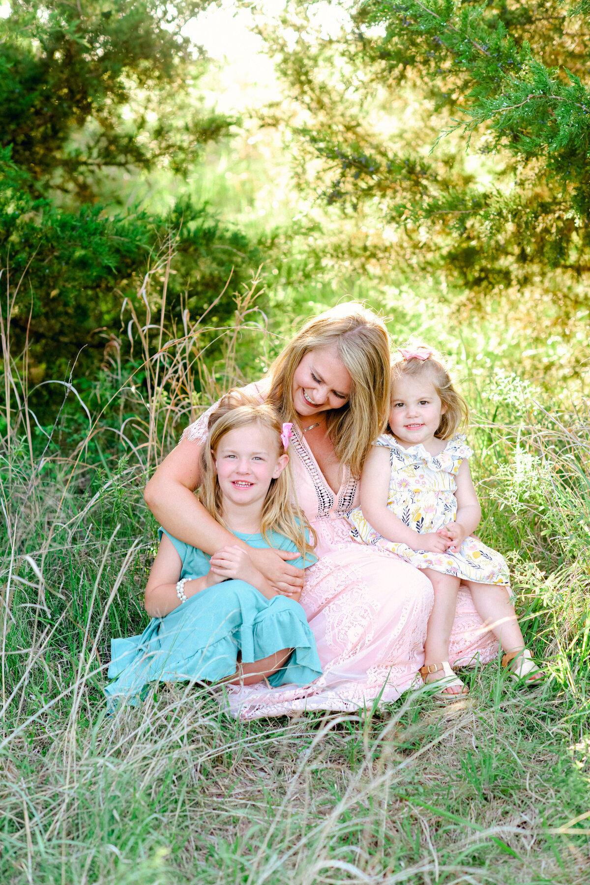 Motherhood session with mom and two daughters in Oklahoma City field.