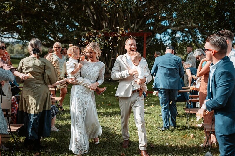 "Experience the joy and love as Maddi & Jeremy, surrounded by their adorable children, step into a new chapter of life together after a heartwarming wedding ceremony.