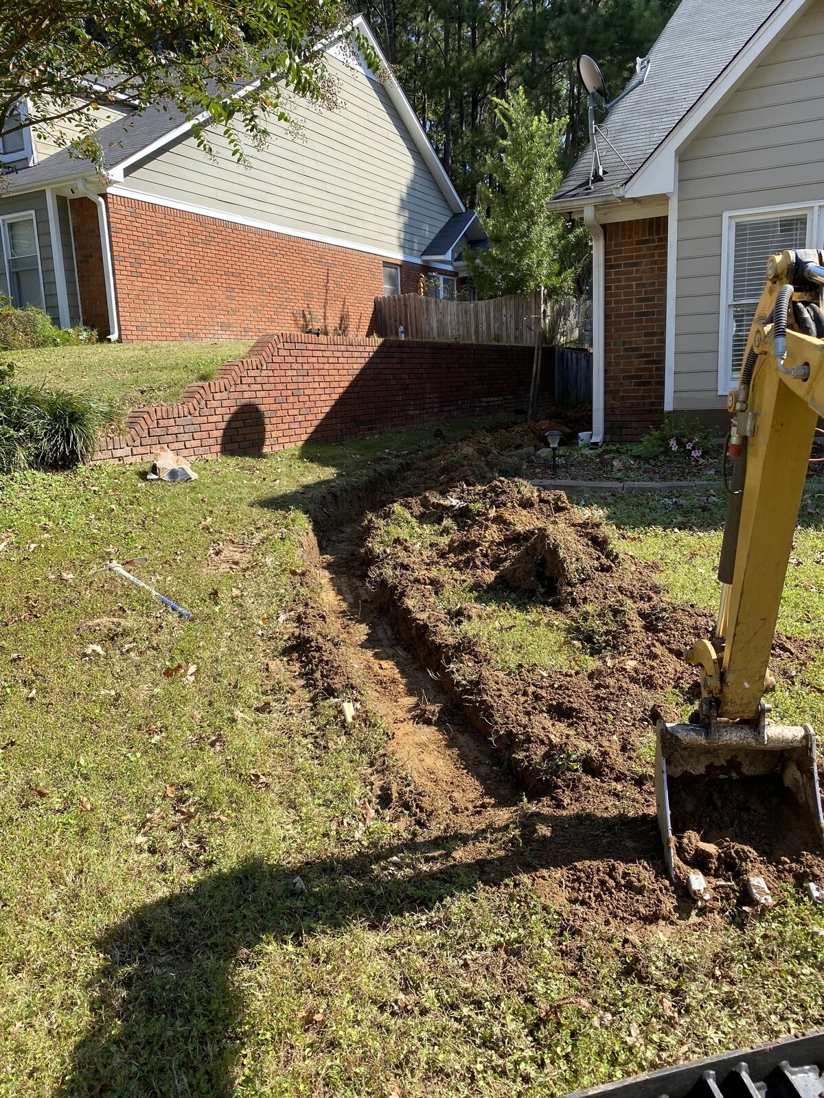 dirt-trench-in-front-yard-between-two-homes