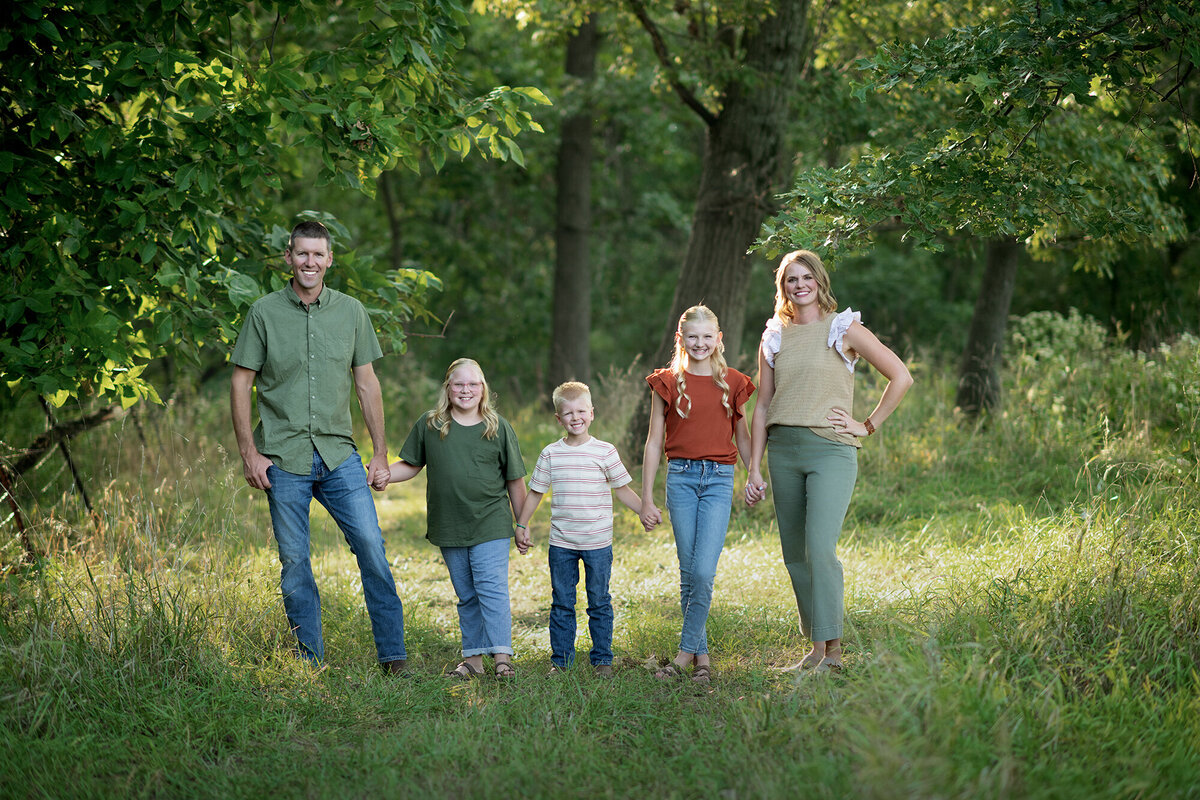 Mom, Dad, and their 3 kids hold hands