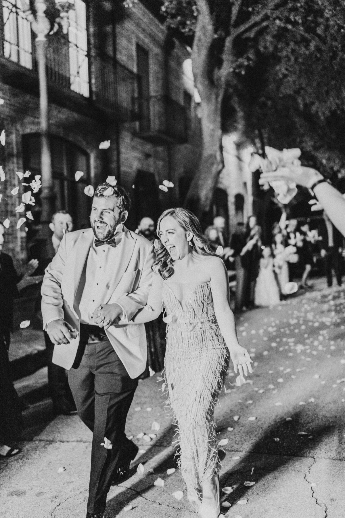 black and white image of bride and groom leaving brennans for their hotel night.