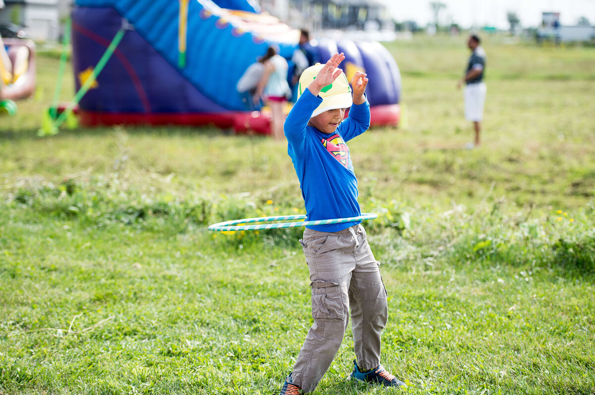 a little boy hoola-hooping at a corporate children's event.  Captured by Ottawa Event Photographer JEMMAN Photography COMMERCIAL