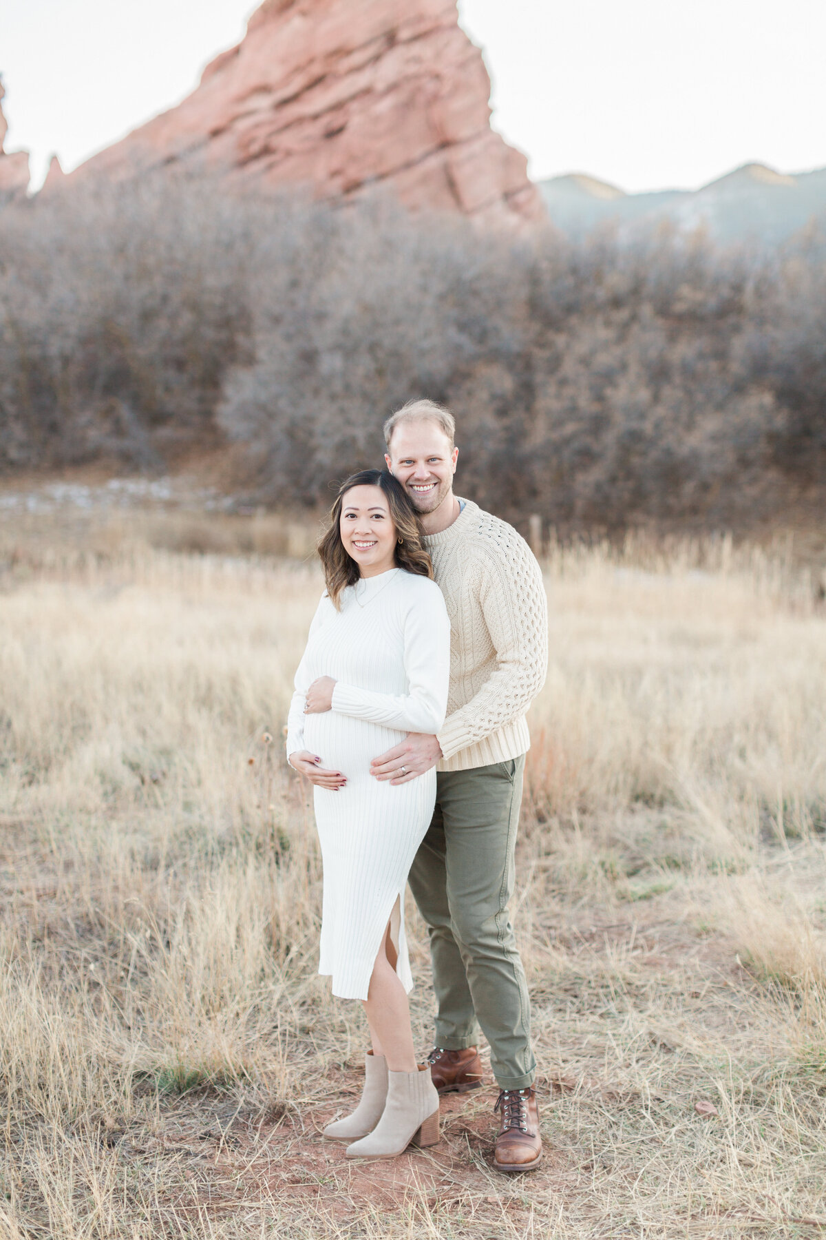 A pregnant mom and her husband during golden hour in Denver