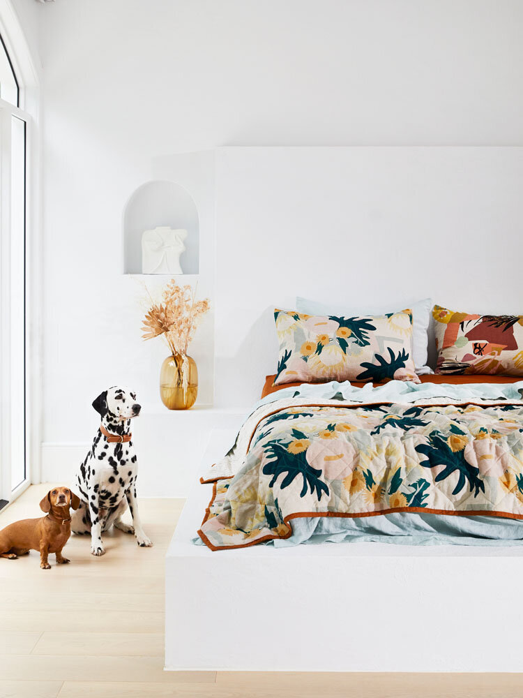 Modern Melbourne bedroom interior with dogs styled alongside bold patterned bedding by interior stylist for residential design.