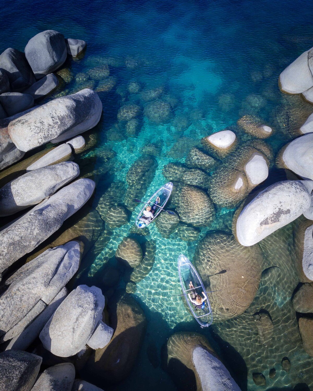 Aerial view of two kayaks on Lake Tahoe surrounded by rocks