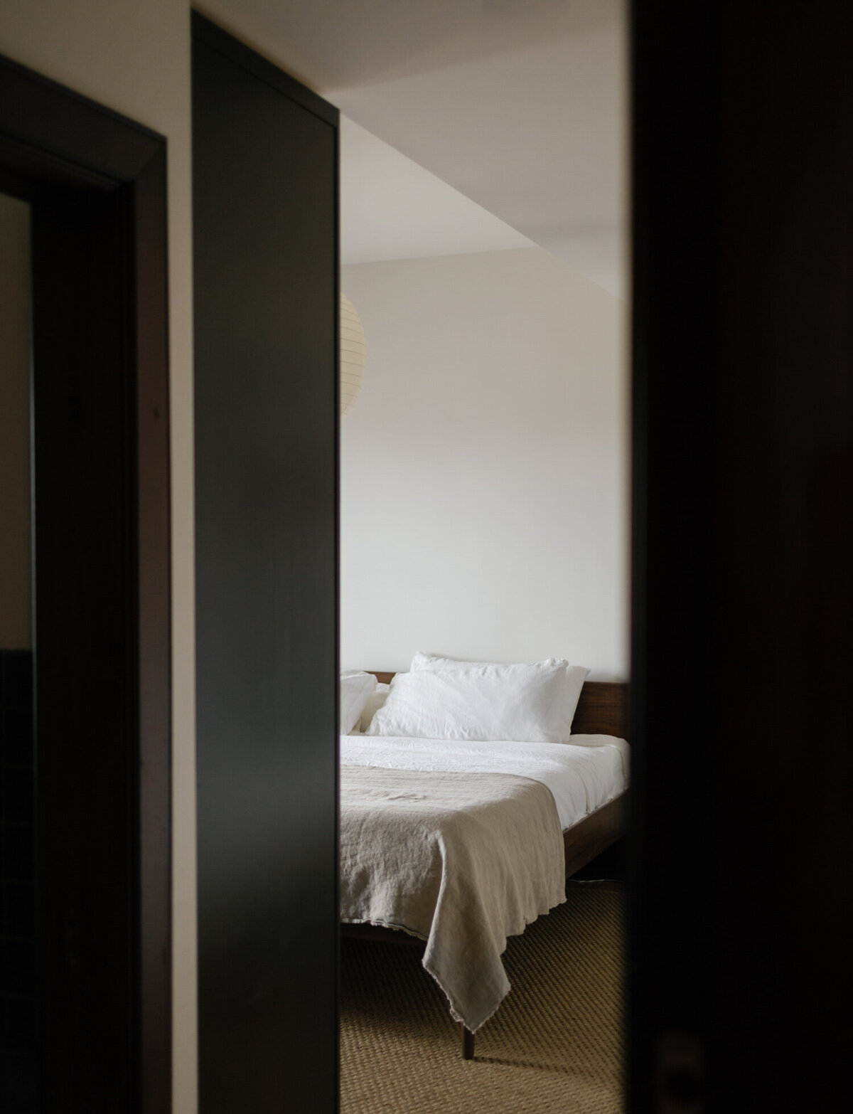 bedroom interior photo, film branding photo of bed with door framing, ALEO Detroit