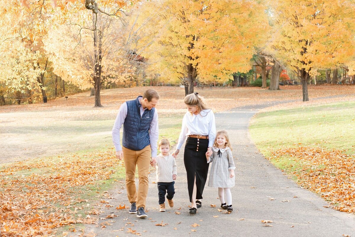 family walking together with fall trees taken by Boston Family Photographer