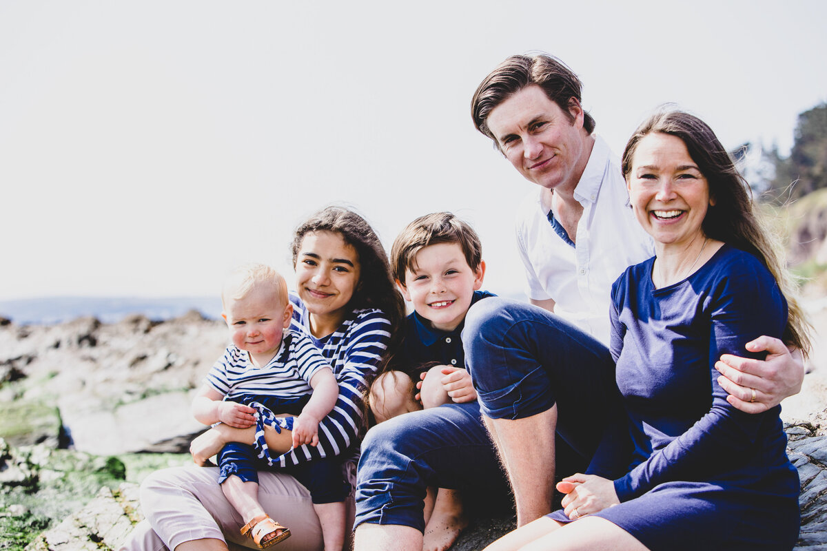 Devon Wedding Photographer Liberty Pearl Photography and family sat together on the beach