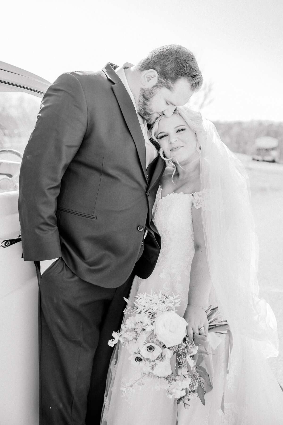 Black and white couple portraits outside of a classic car