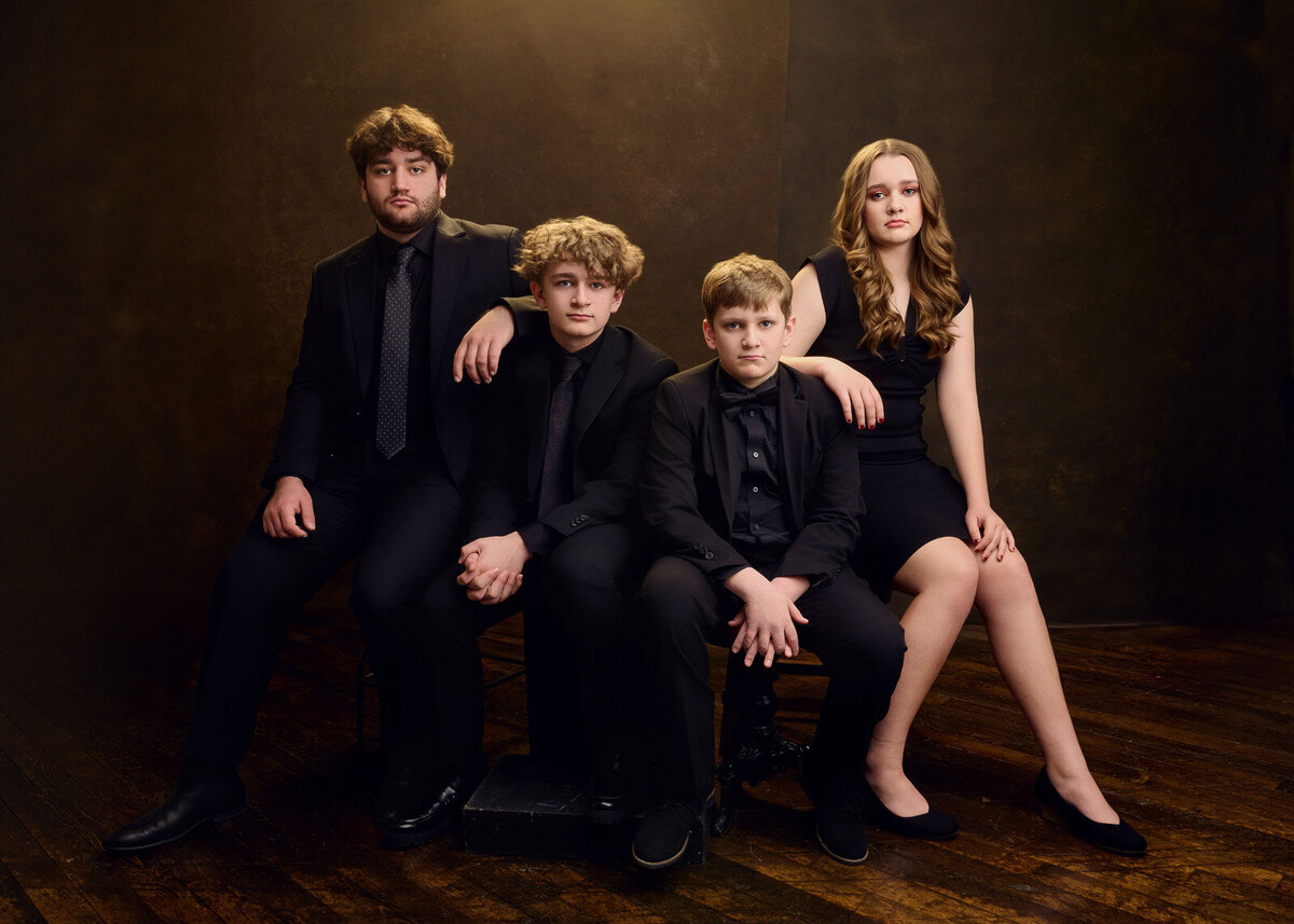 Elegant Family Portrait of Four Siblings in Formal Black Attire-58