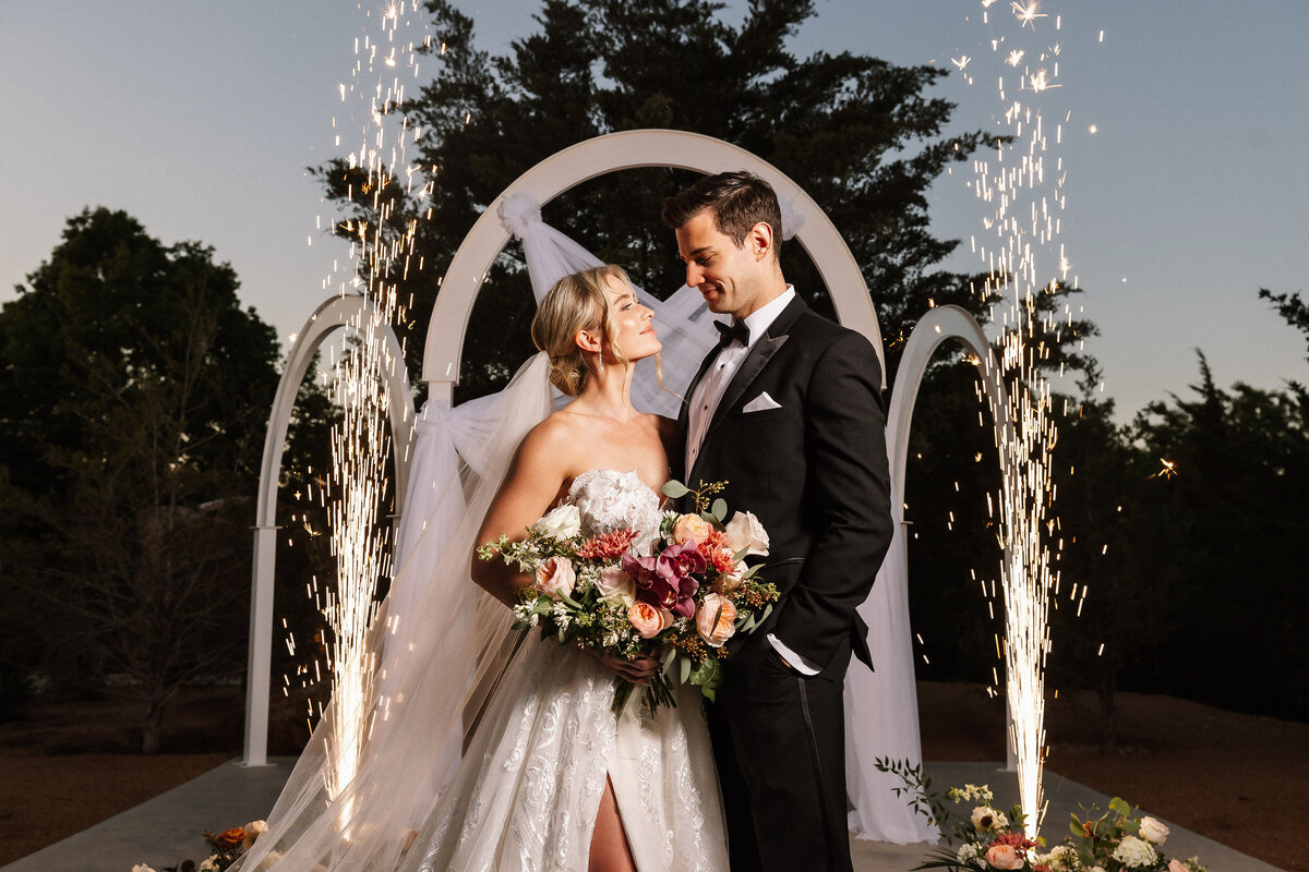 Bride and groom take advantage of the arches for the perfect photo opp