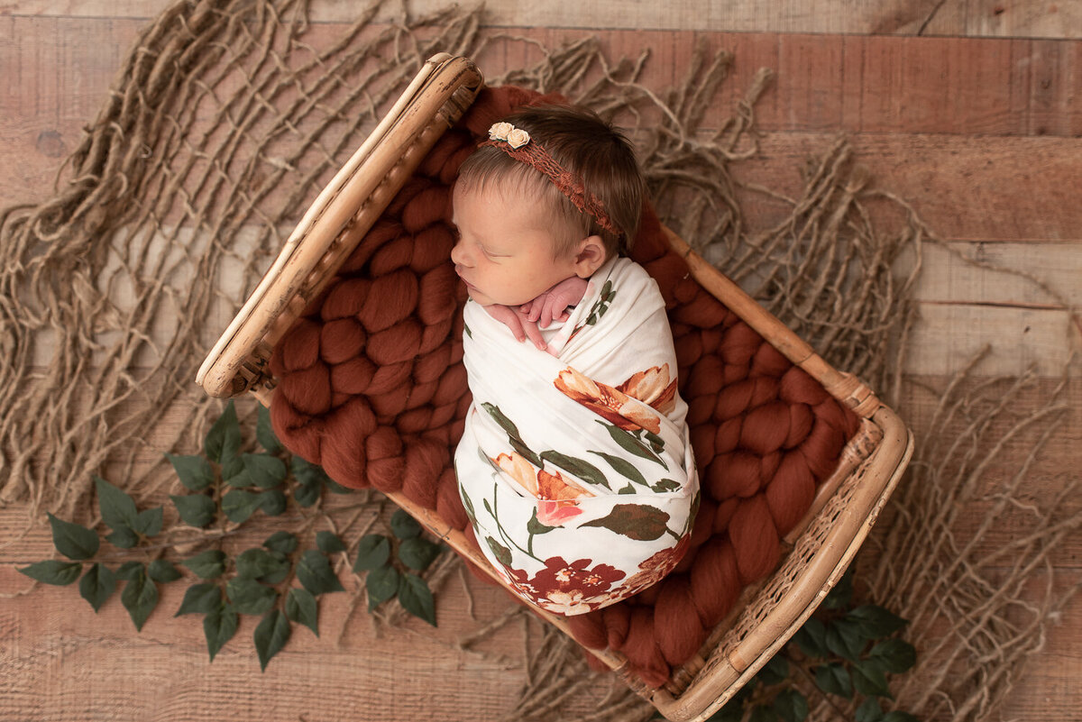 Baby girl wrapped in floral blanket at newborn session in Canton, CT | Sharon Leger Photography