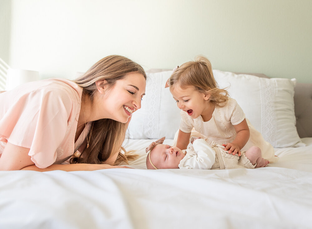 Mom with toddler and baby at home