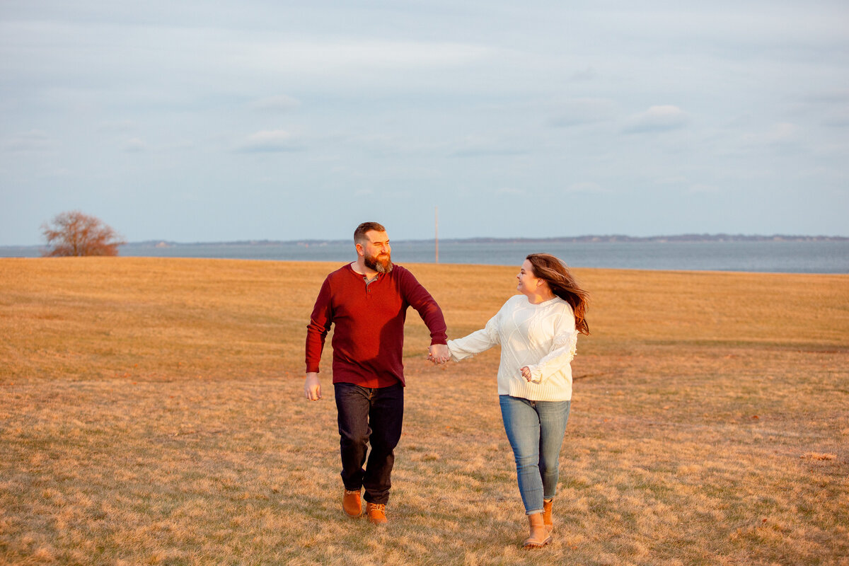 Couple run and laugh during their engagement session.