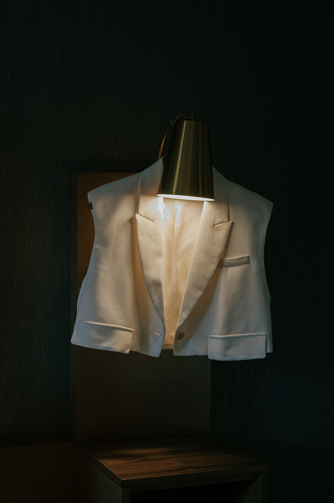 A dress shirt illuminated by a lamp head.