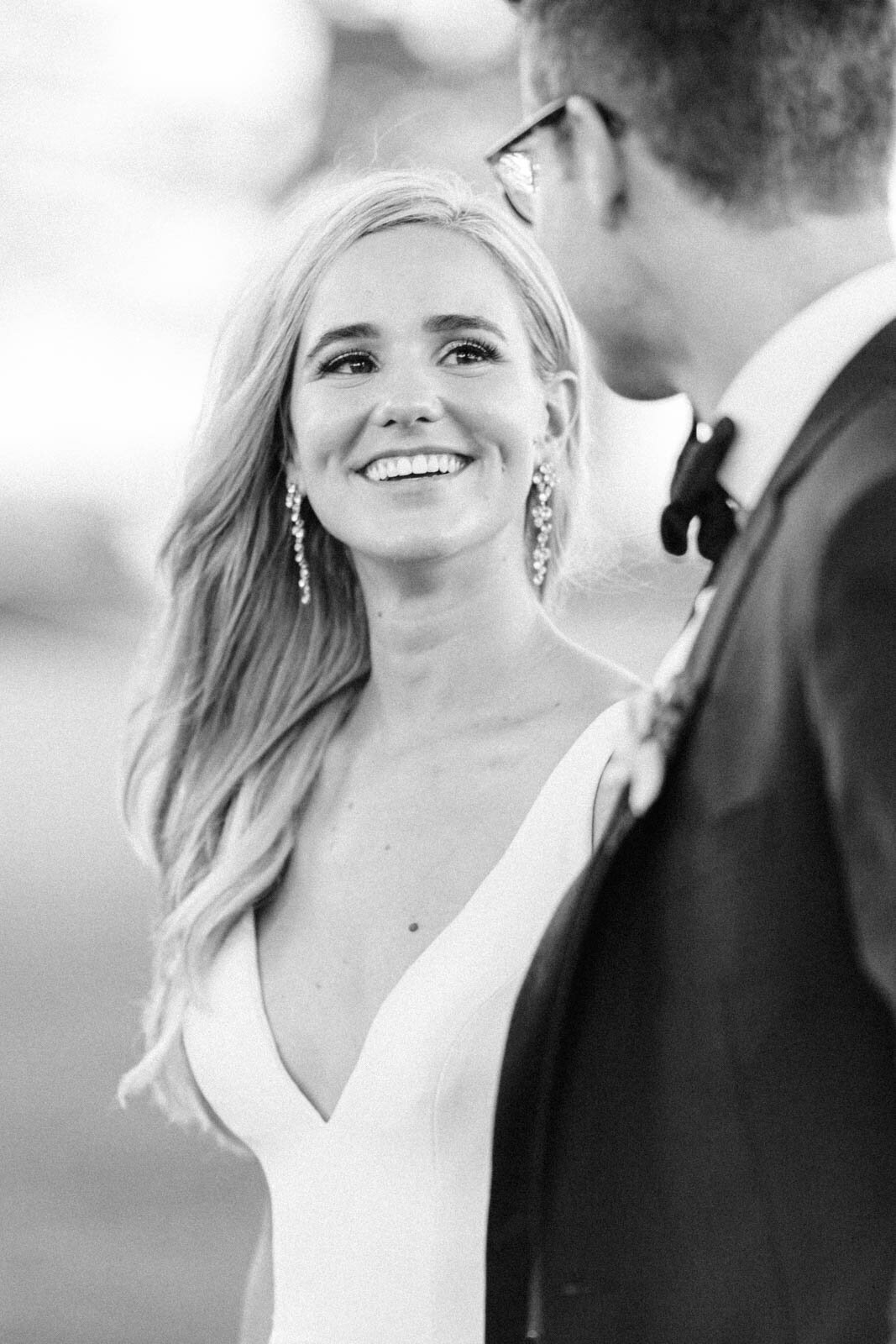 Bride captured naturally gazing a the groom while walking at sunse