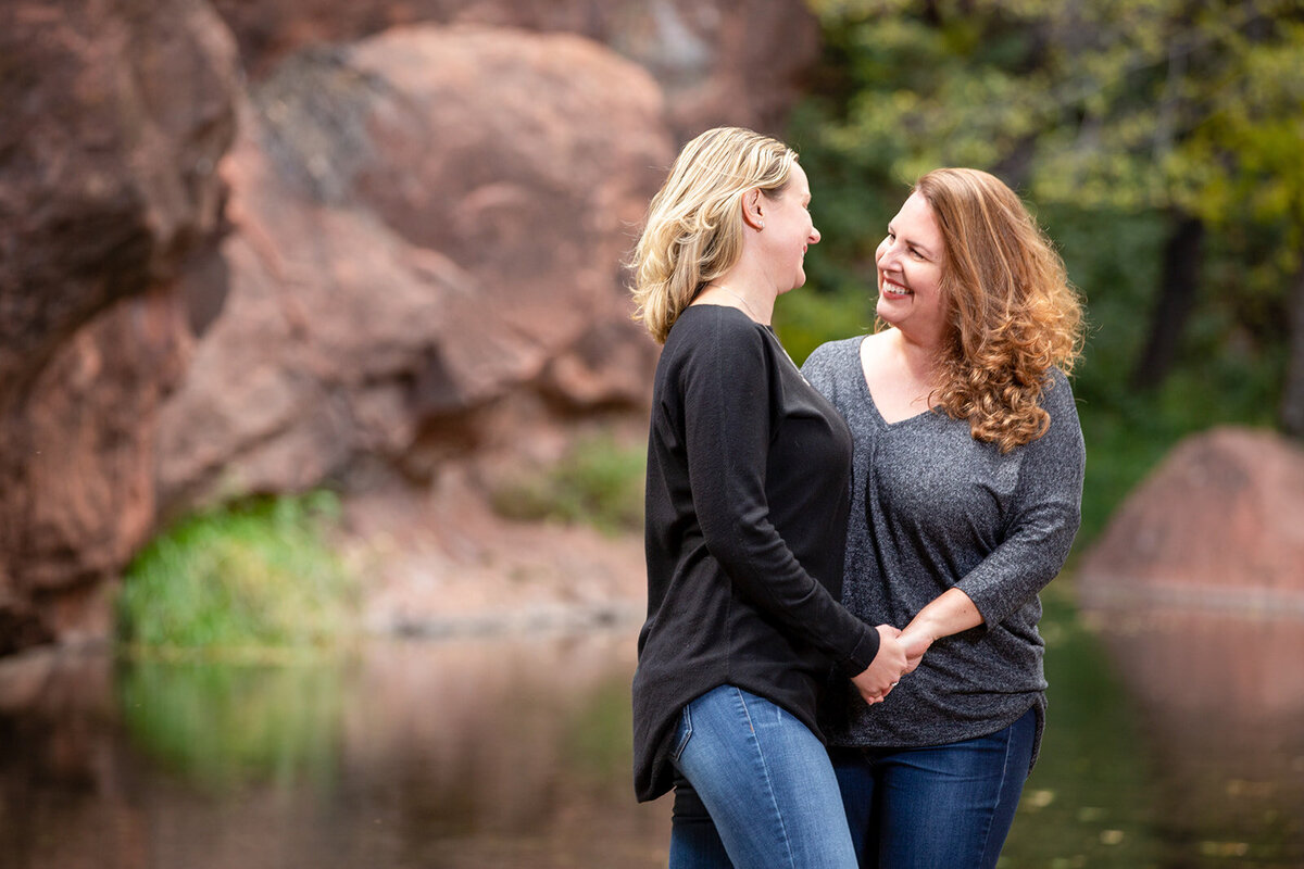 Engagement session in Sedona with beautiful red rocks and water by DePoy Studios.