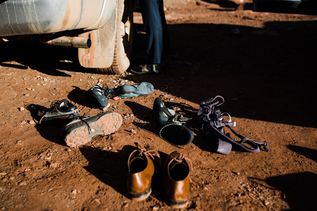 in the arizona desert the groom kisses brides head with a storm gathering behind the,