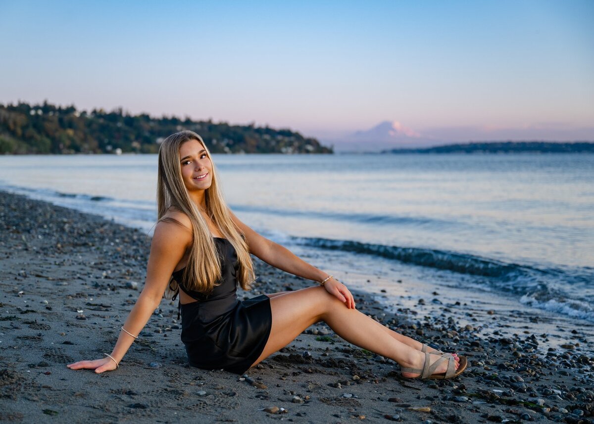 kirkland senior girl in black dress seated at beach mountain rainier