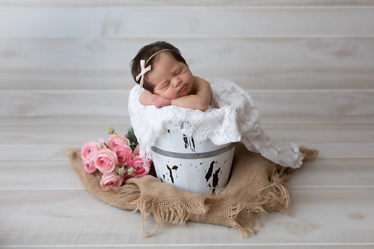 baby-girl-asleep-in-white-bucket