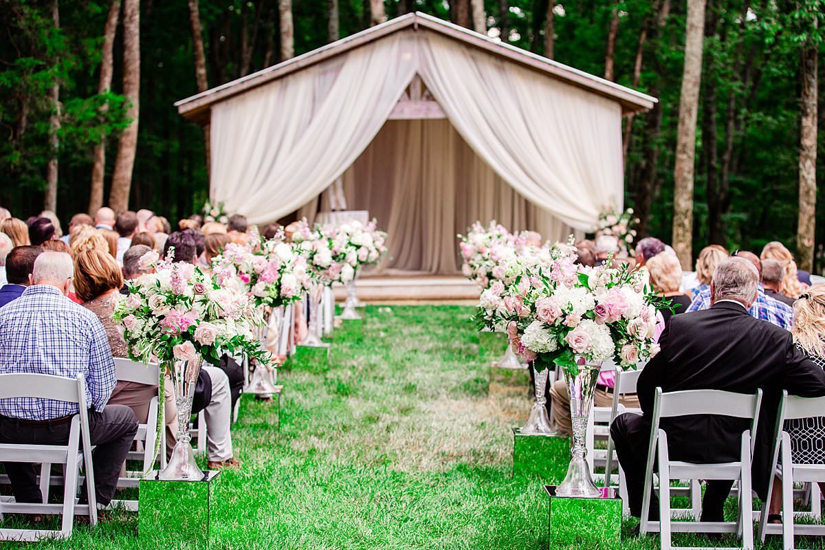 Outdoor ceremony location draped and with flowers at Saddlewood Farm