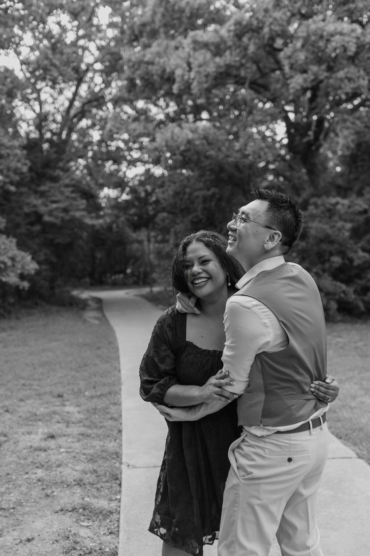 An engaged couple playfully embraces at Stone Creek Park in Flower Mound by Fort Worth Wedding Photographer, Megan Christine Studio