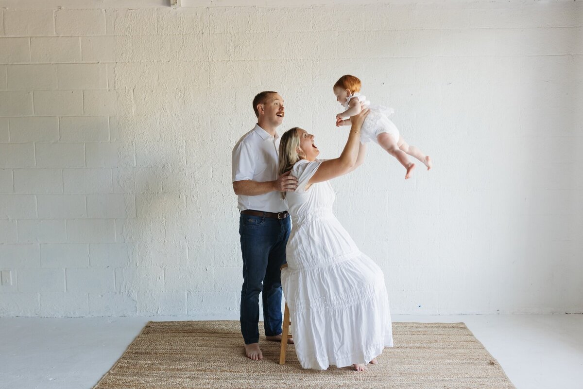 parents playing with their baby