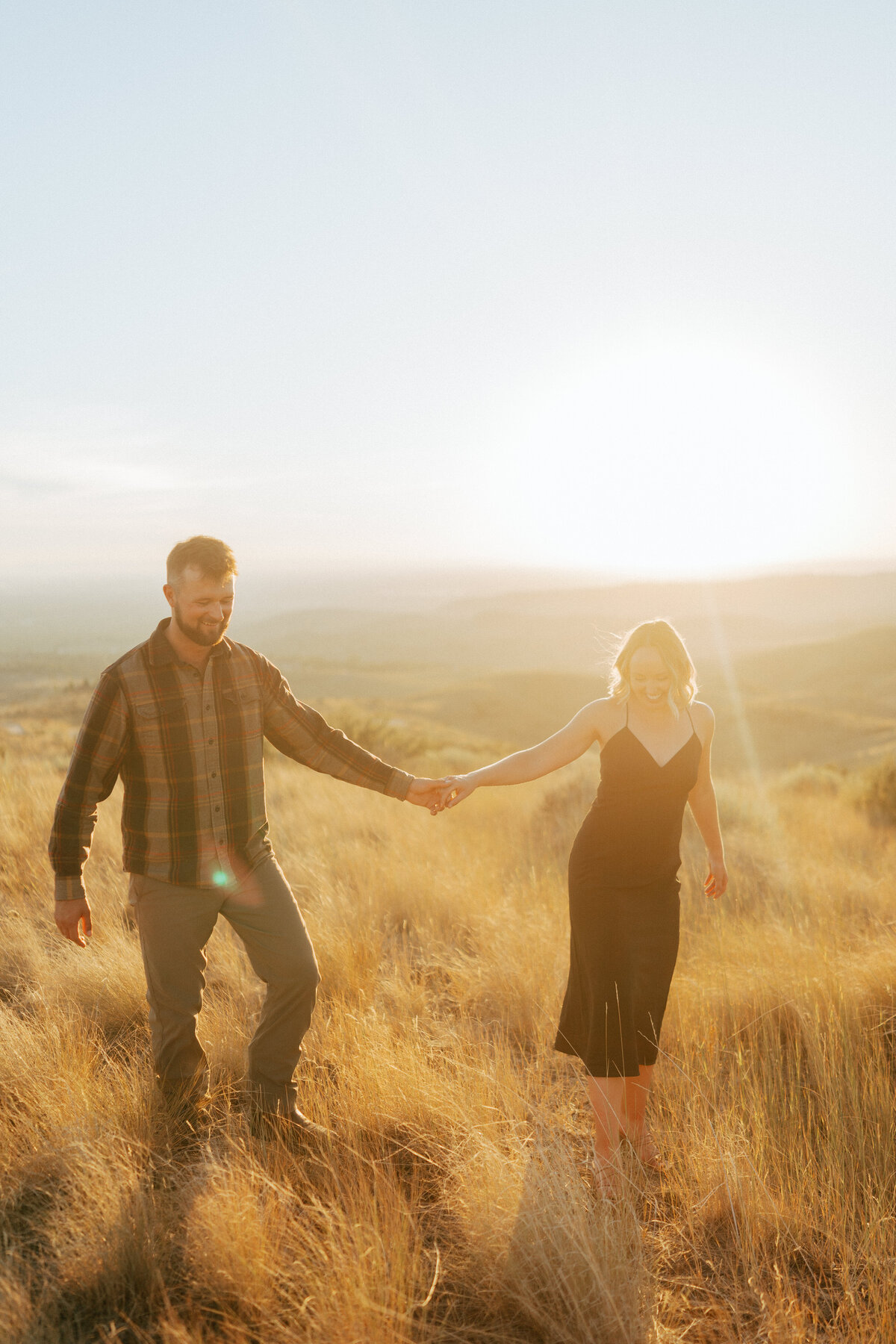 Couple during golden hour engagement shoot in Boise, Idaho wedding/elopement - photographed by The Storytellers