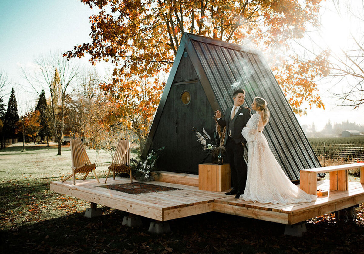jaime-ta-creative-cabin-elopement-bride-groom-outside-dionnekrausphotography