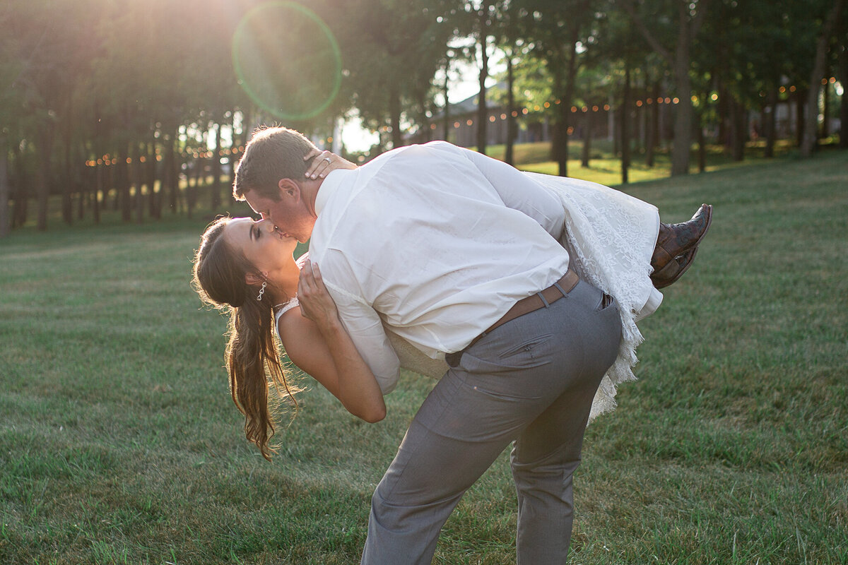 wedding-photography-bride-groom-carrying-kissing-sunset