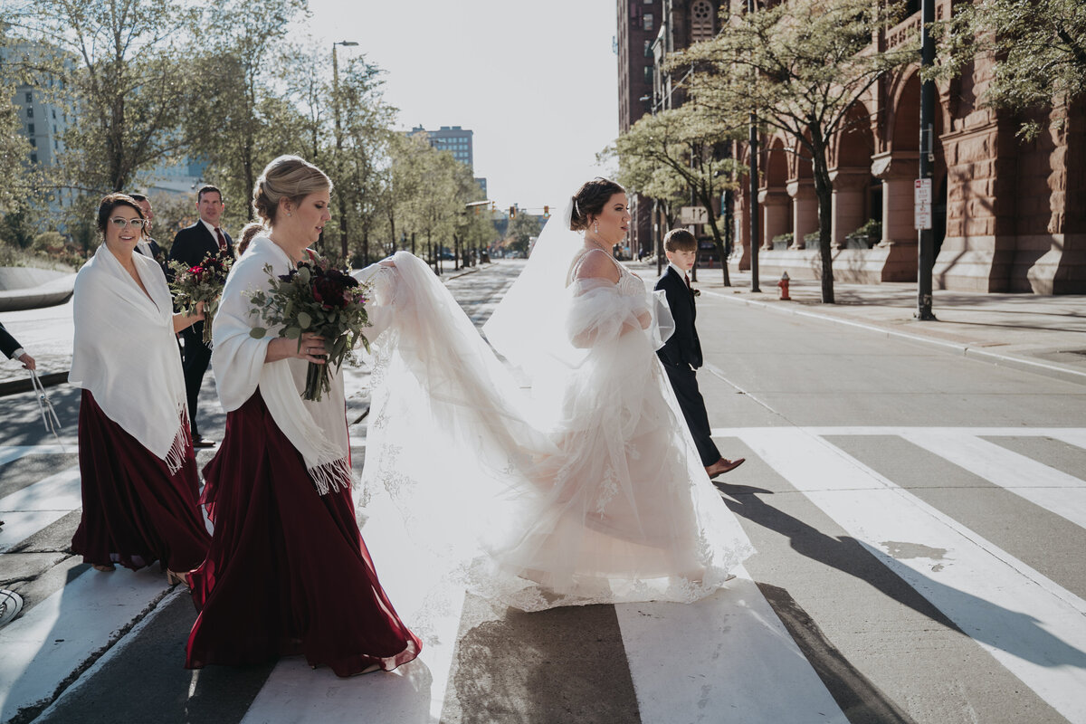Bride and bridesmaid walk through downtown Cleveland