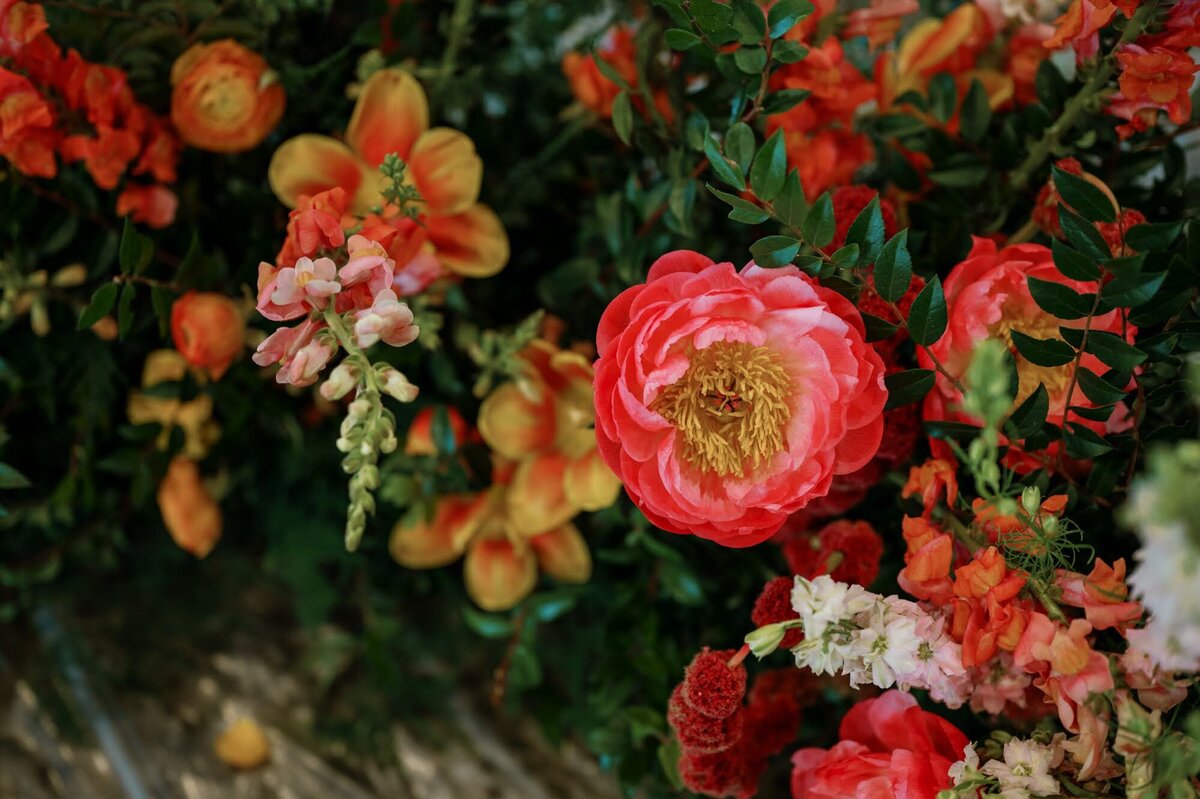 Beautiful wedding florals of bright pinks and oranges.