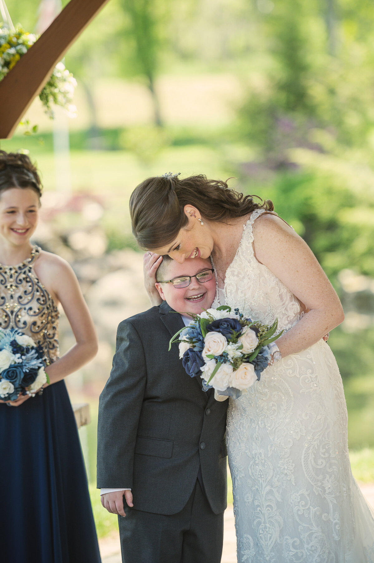 Bride hugging son on her wedding day.