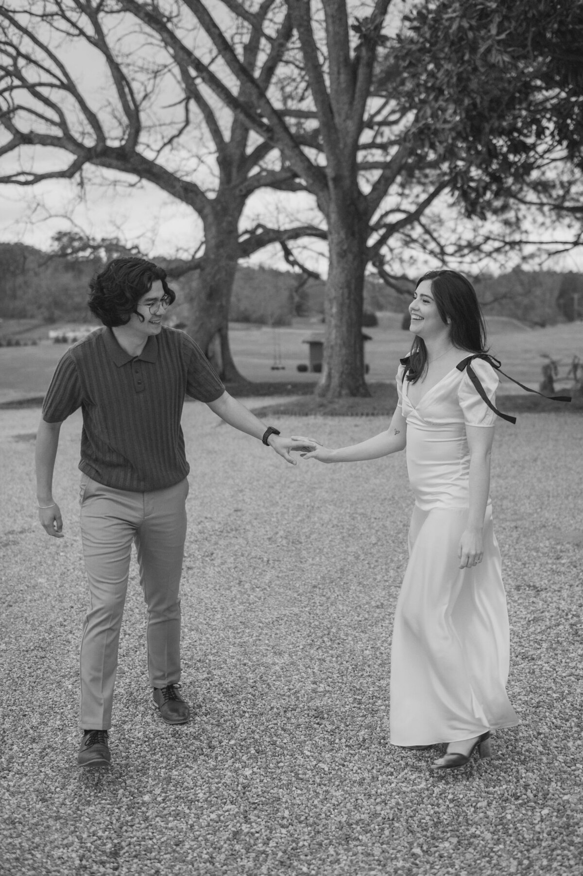 A couple holds hands while walking around