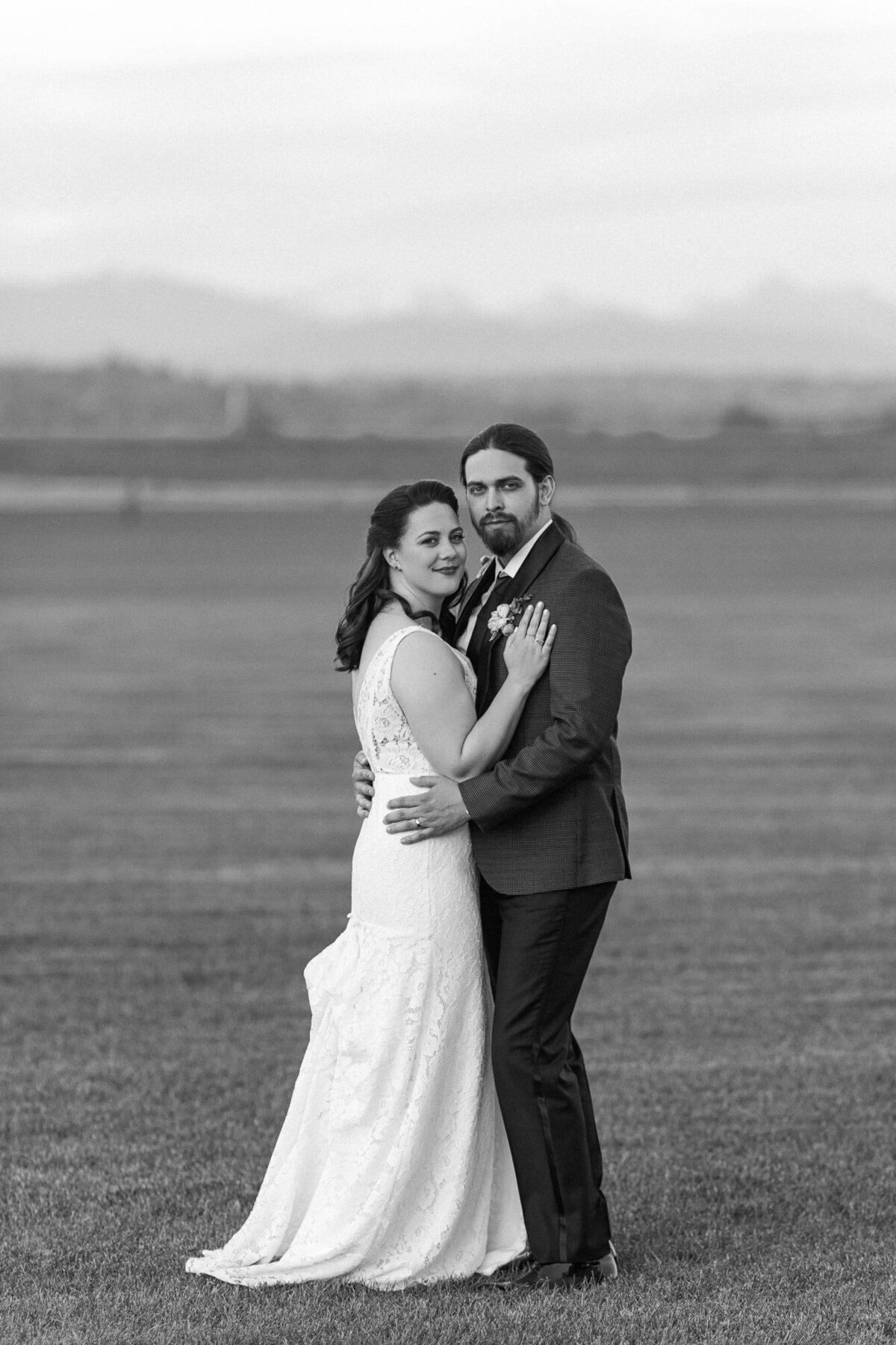 Black-and-white-photo-of-bride-and-groom-on-their-wedding-day-at-outdoor-venue-Hidden-Meadows-in-Snohomish-WA-photo-by-Joanna-Monger-Photography