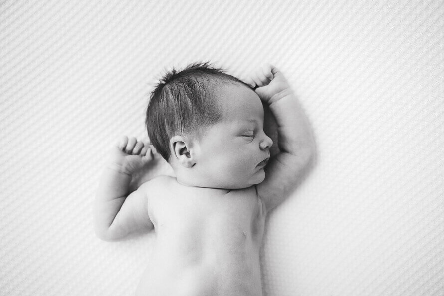 Baby sleeps on back for his photoshoot.