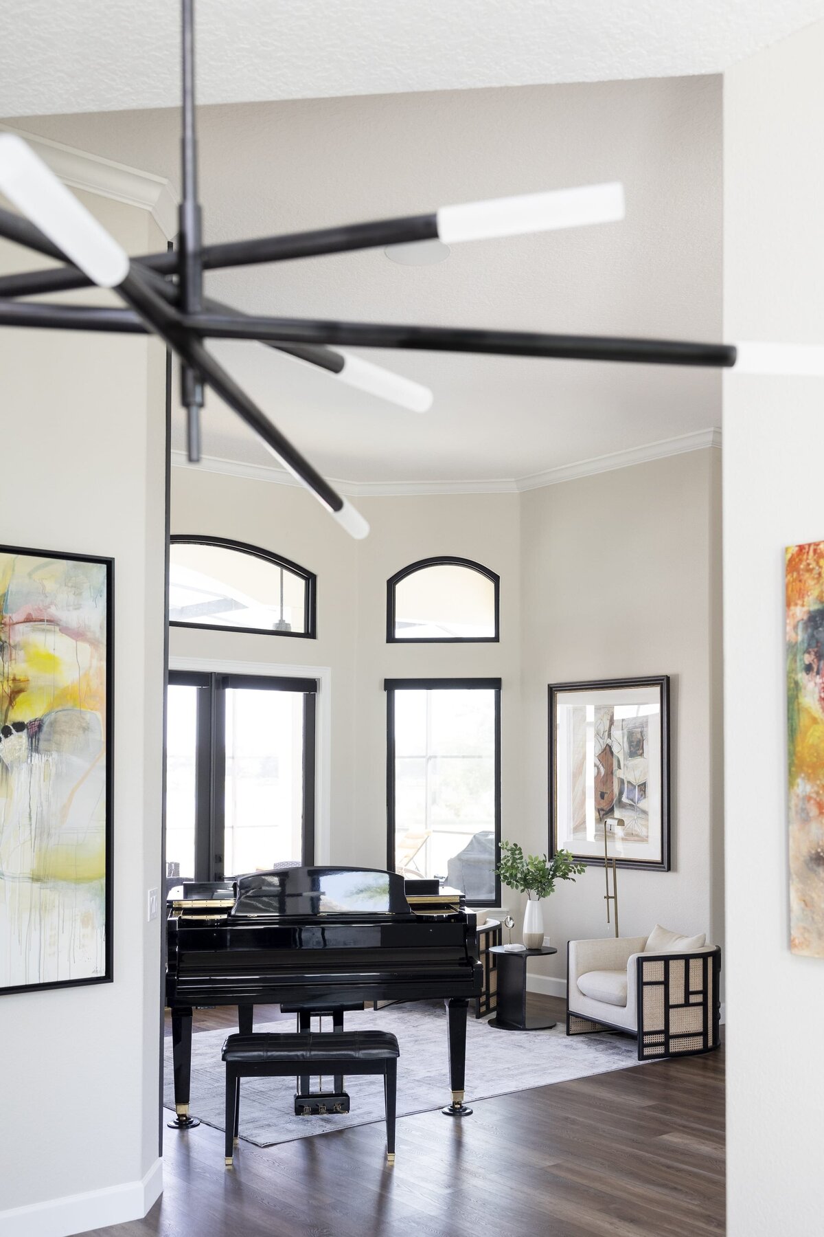 dewine design orlando interior designer windermere full home renovation entry area with black piano and black trimmed windows