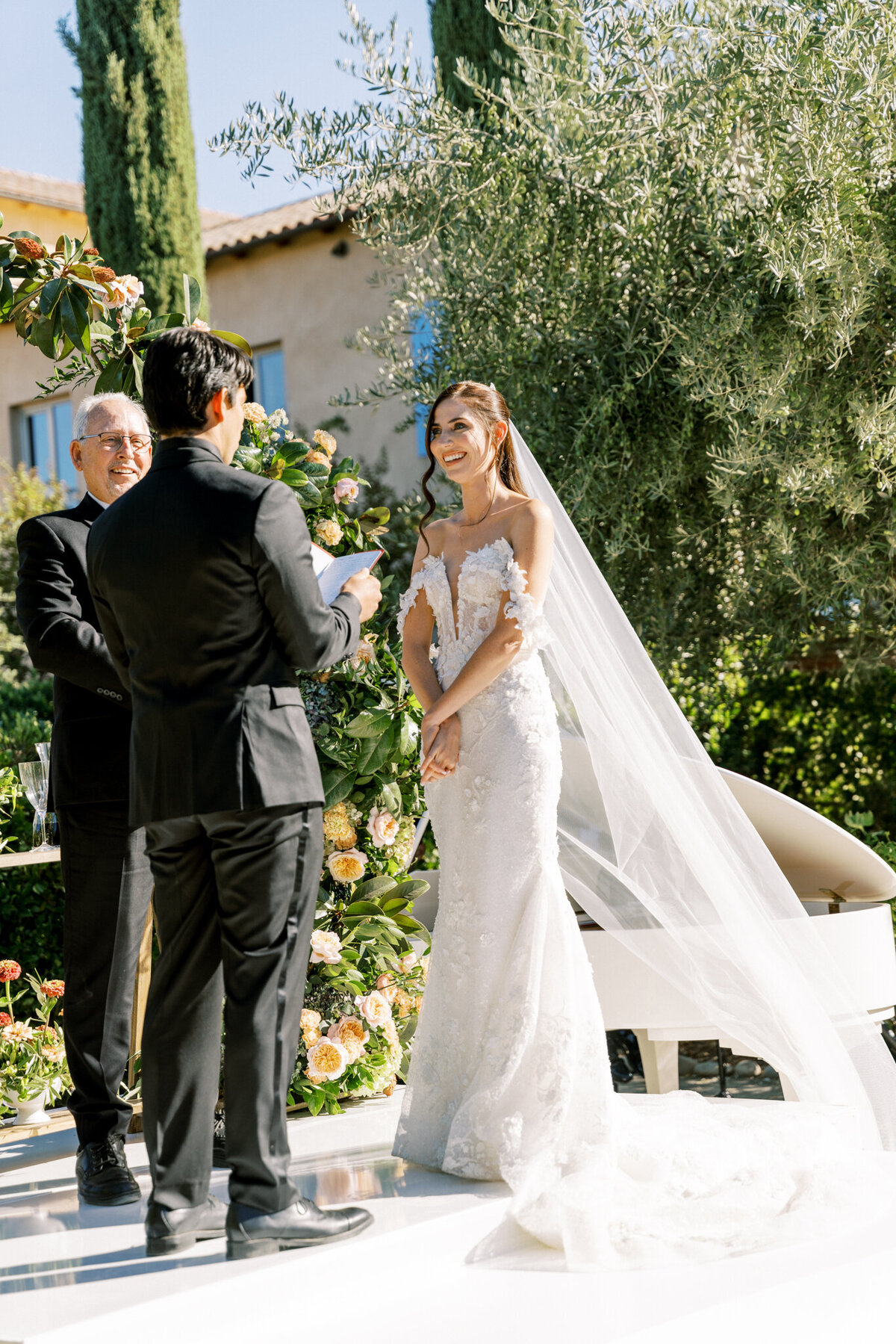 Emotional vow exchange under the sun at Allegretto Vineyard—joyful bride and heartfelt groom in a picture-perfect ceremony moment.
