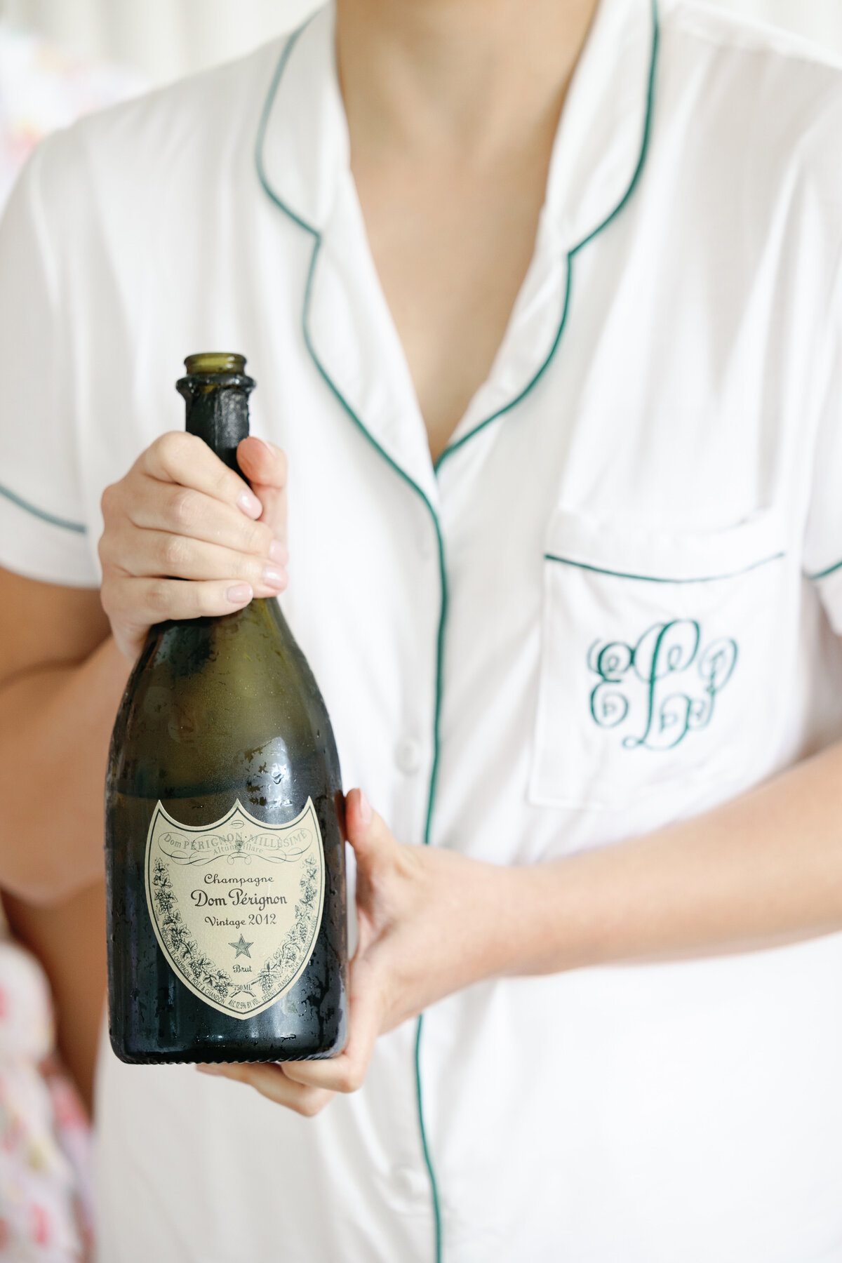 female holding a bottle of Don Perignon