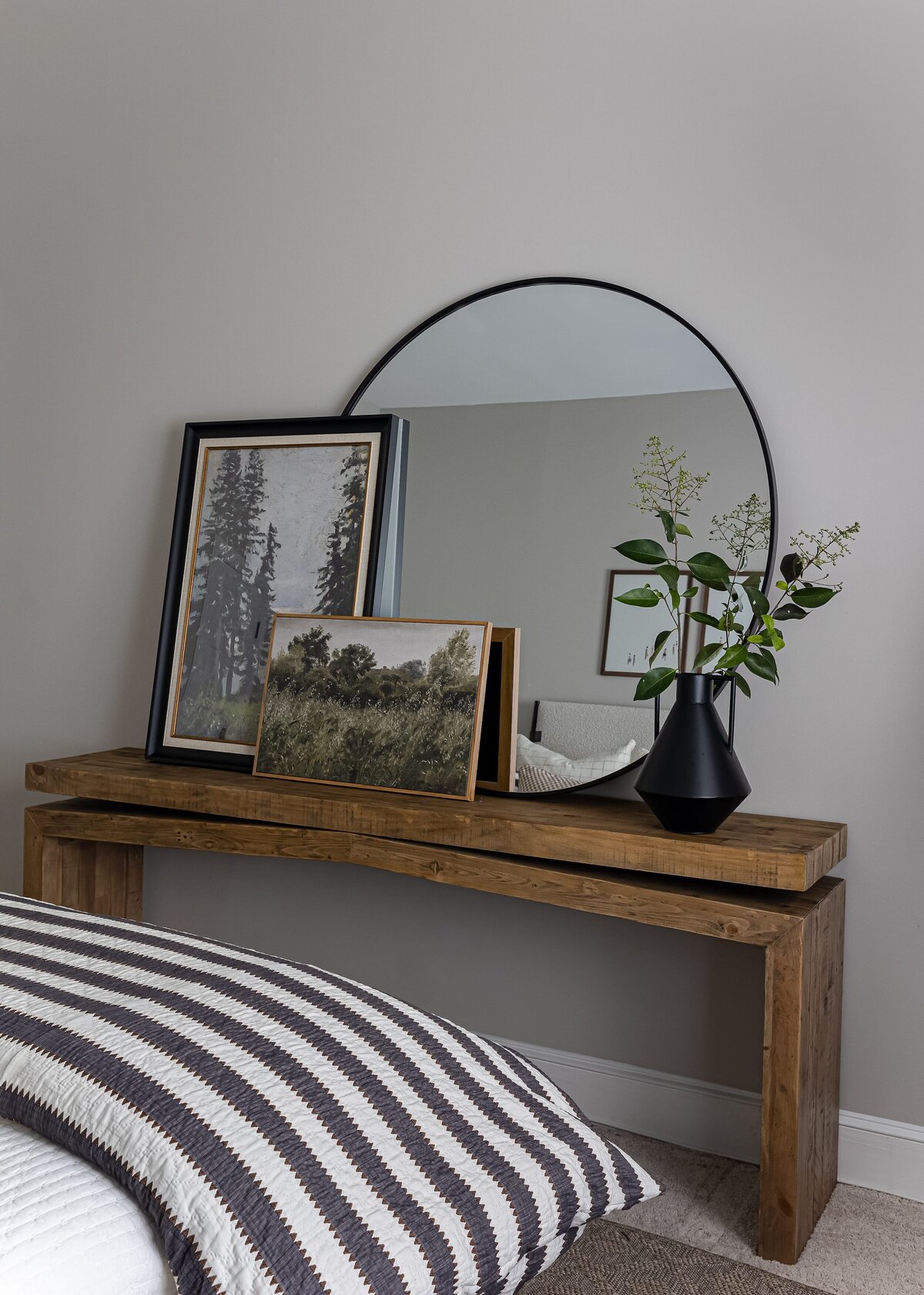 melinda chesson interiors meadowood place black framed round mirror on wooden table in bedroom