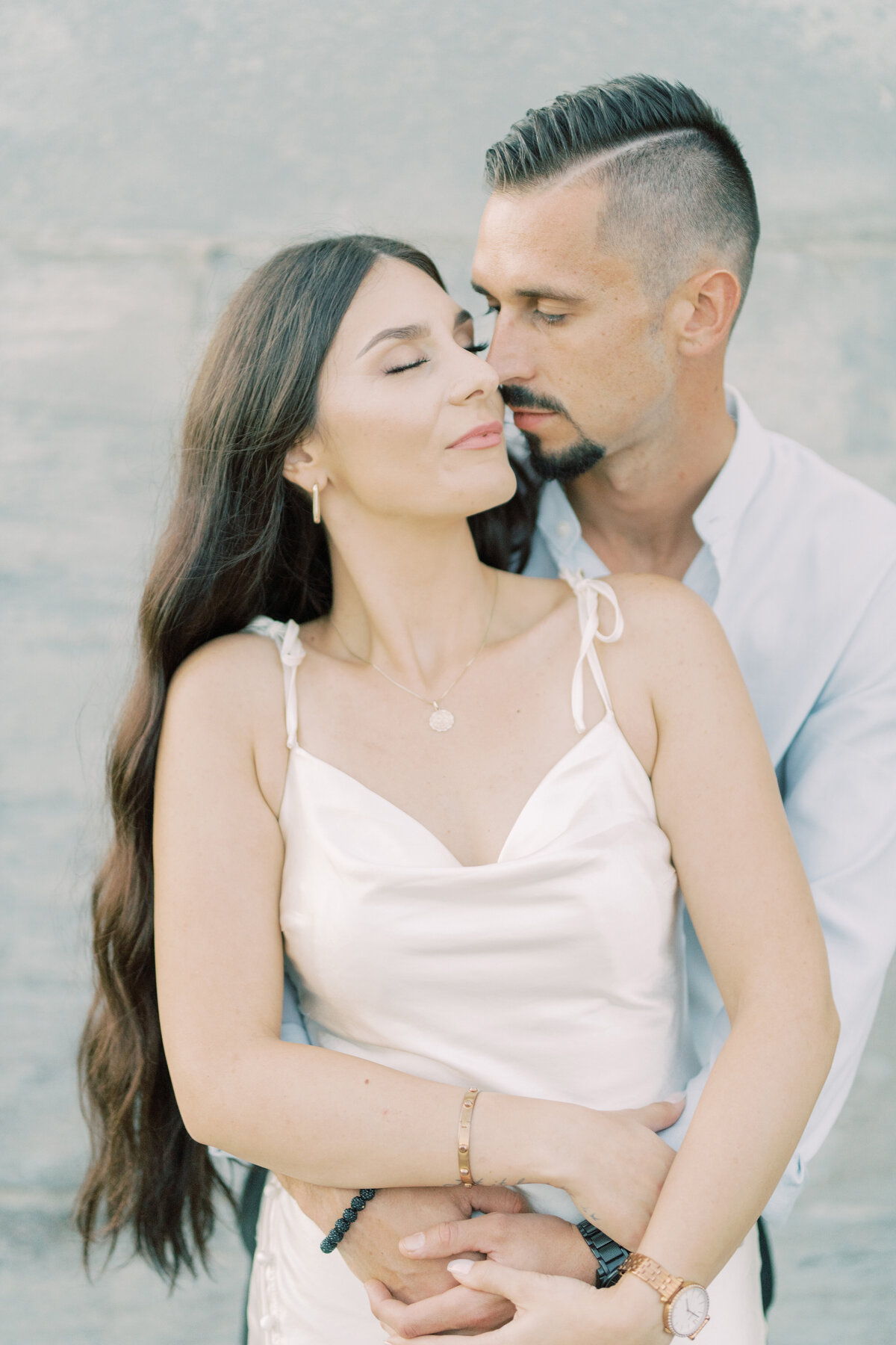 Tender embrace between the couple at Toronto’s RC Harris Water Treatment  Plant, with the bride-to-be leaning into her partner, eyes closed in bliss