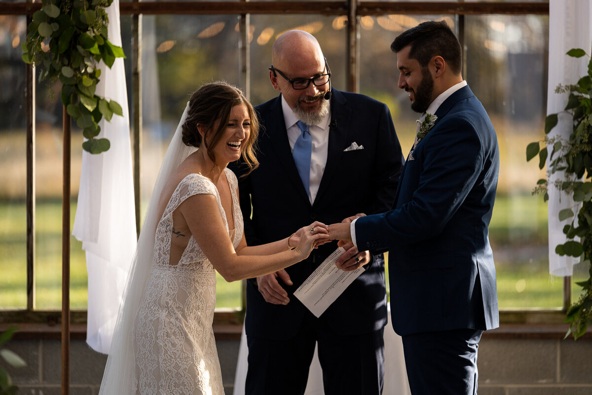 Bride and groom laugh during their wedding vows